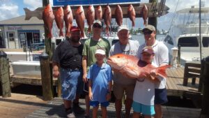 A Group of People Holding an Orange Fish