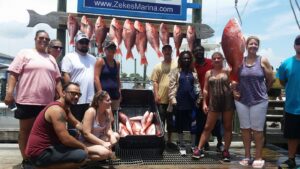 A Group of People Posing With Fish From Fishing